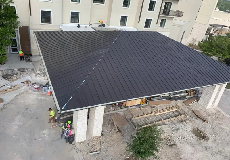 Metal roofing installation team working on a commercial building in Passaic