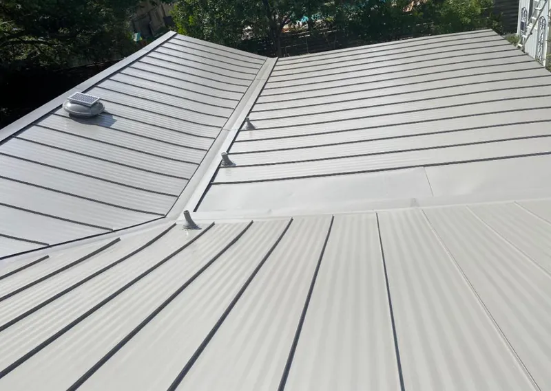 Solar attic fan installed on a metal roof for Roof Ventilation in Passaic